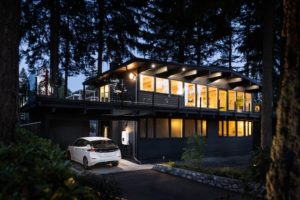 Ultium home with an EV charging at night.