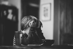 Black and white photo of stressed out child.
