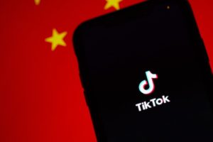 TikTok opening screen in front of a Chinese flag.
