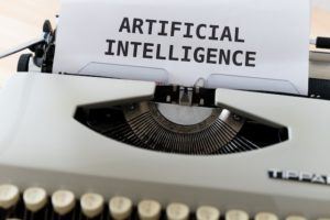 Typewriter with page displaying "Artifical Intelligence."